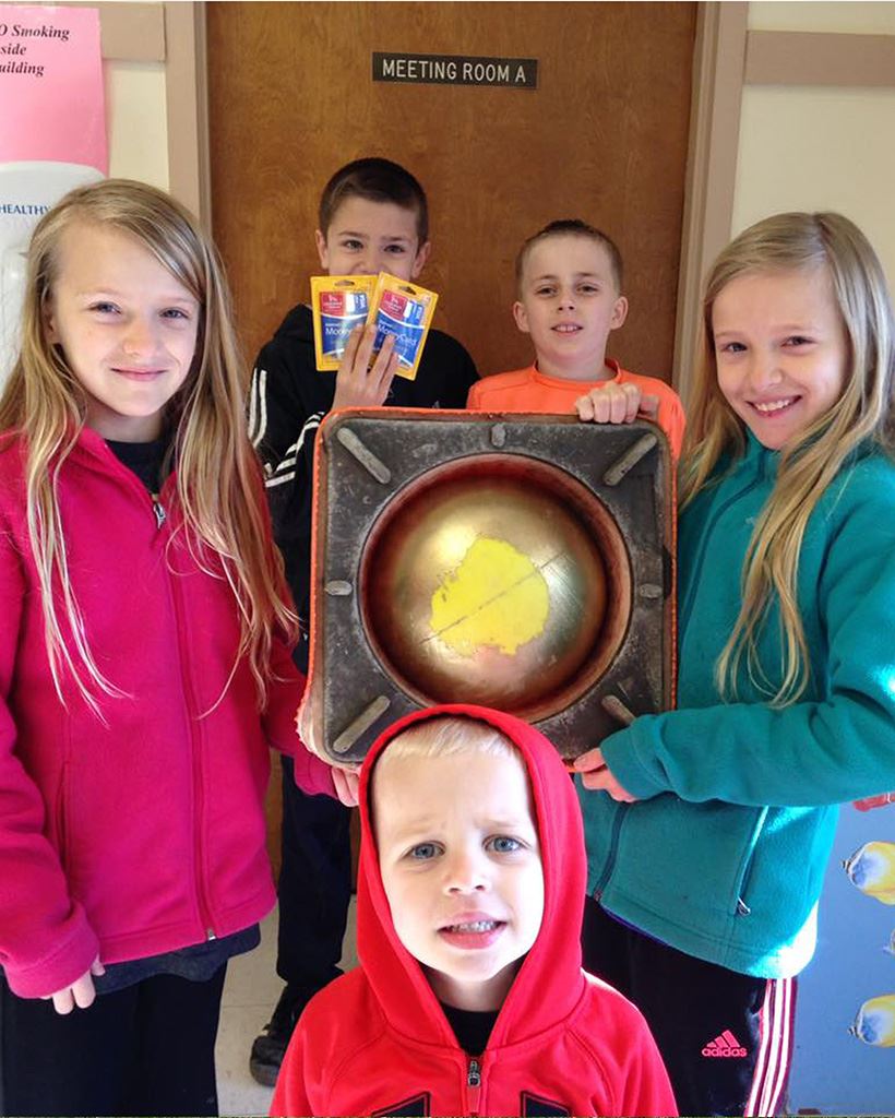 Five children holding prizes from their egg hunt.